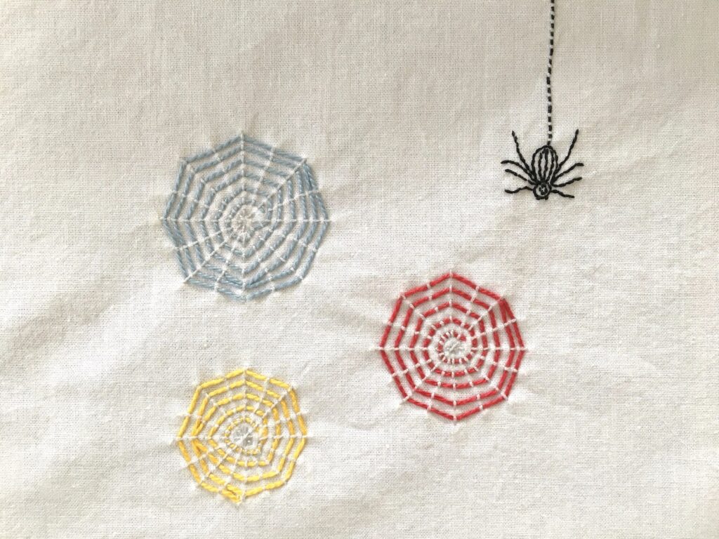Colorful Webs Embroidery Project featuring three spider webs and one spider