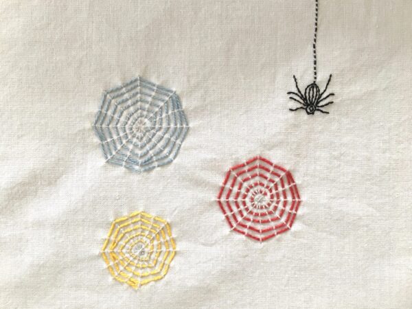 Colorful Webs Embroidery Project featuring three spider webs and one spider