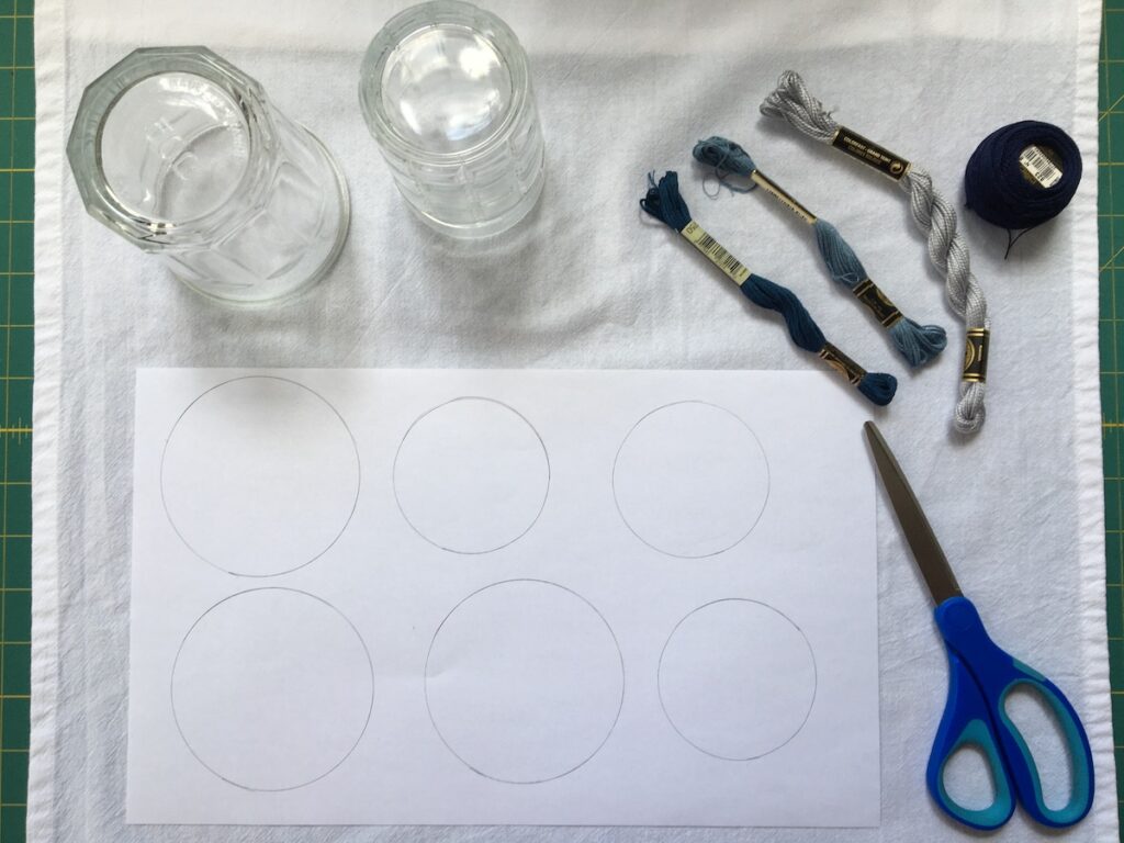 Supplies needed to stitch soap bubble dish towel project - including threads, scissors, circle shapes