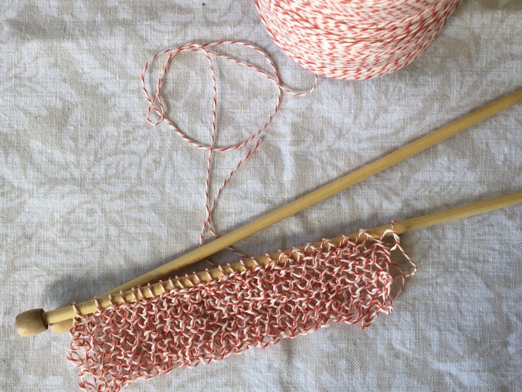 Swatch knitted with red and white bakers string