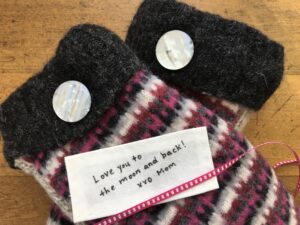 Handmade cotton clothing label laying on mittens